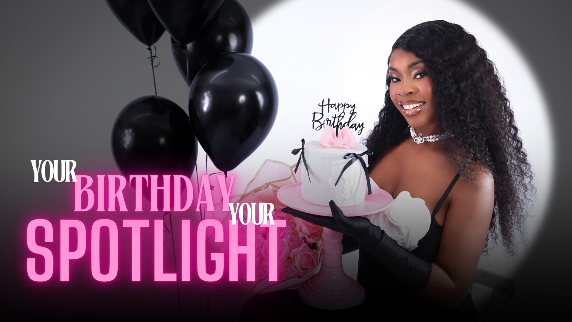 Woman in an elegant dress posing for her birthday photoshoot with stylish decor in the background.