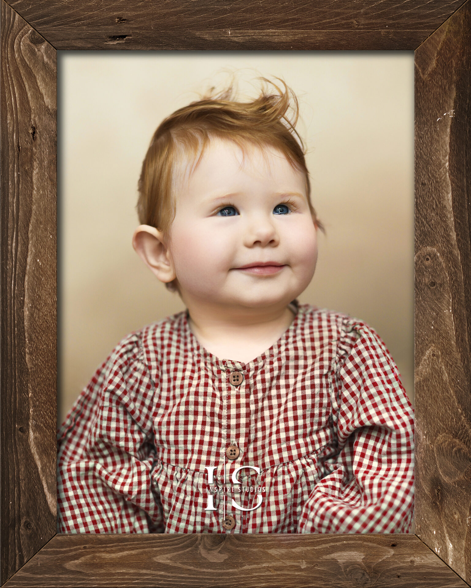 A curious baby sitting up and looking at the camera during a professional photoshoot in London.