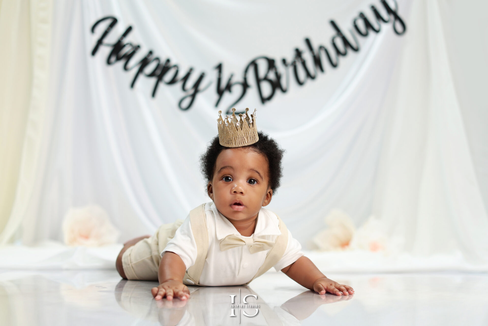 Baby enjoying a fun and colorful half birthday photo session in a studio.