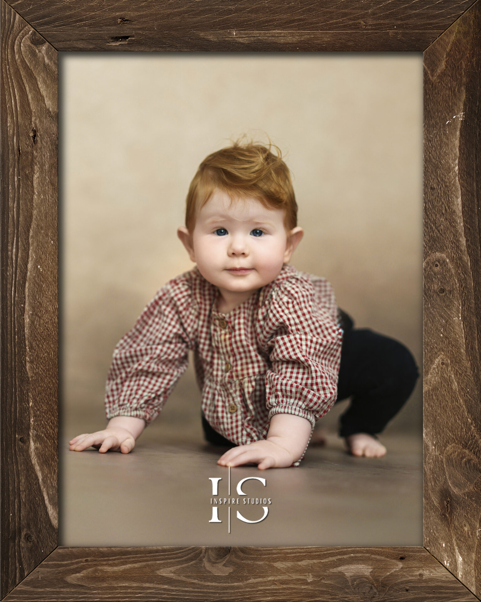 A happy baby clapping hands during a sitter baby photoshoot in a professional London studio.