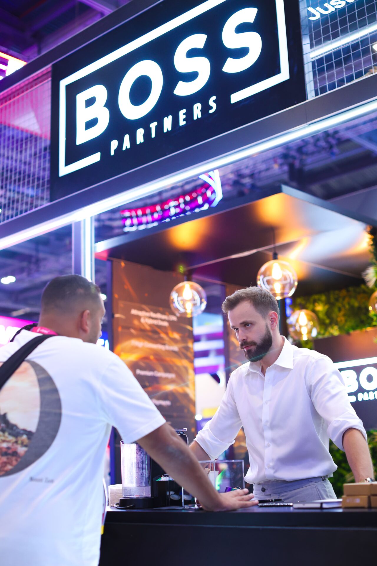 Photography at a London trade show booth with attendees