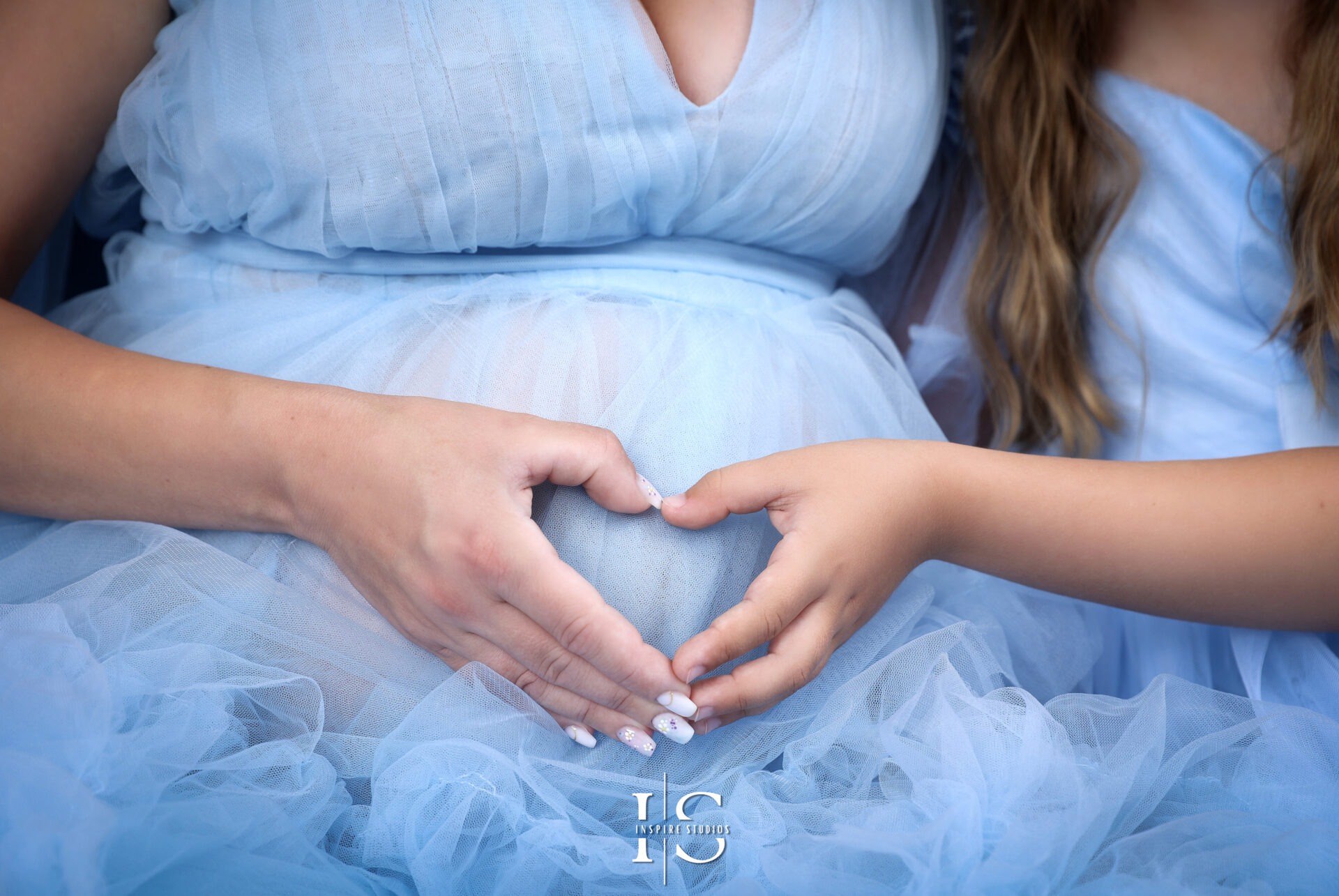Silhouette of pregnant woman in Cinderella gown with backlight