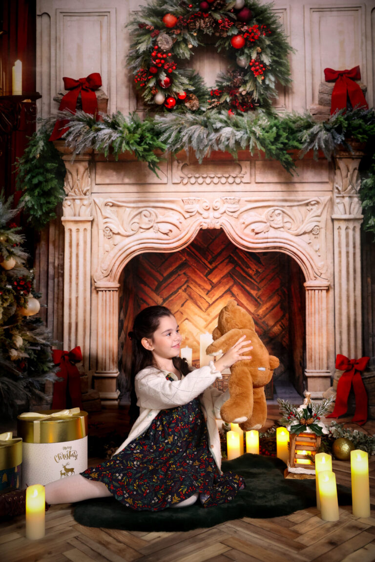 A cozy Christmas room with a classic fireplace, Christmas tree, and traditional red and green decorations.