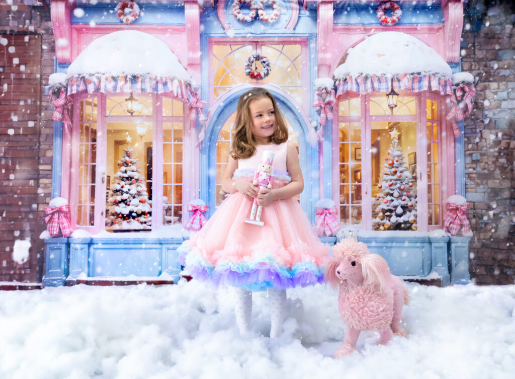 Barbie's Christmas photoshoot with Barbie-themed holiday decor and pink tree decorations.