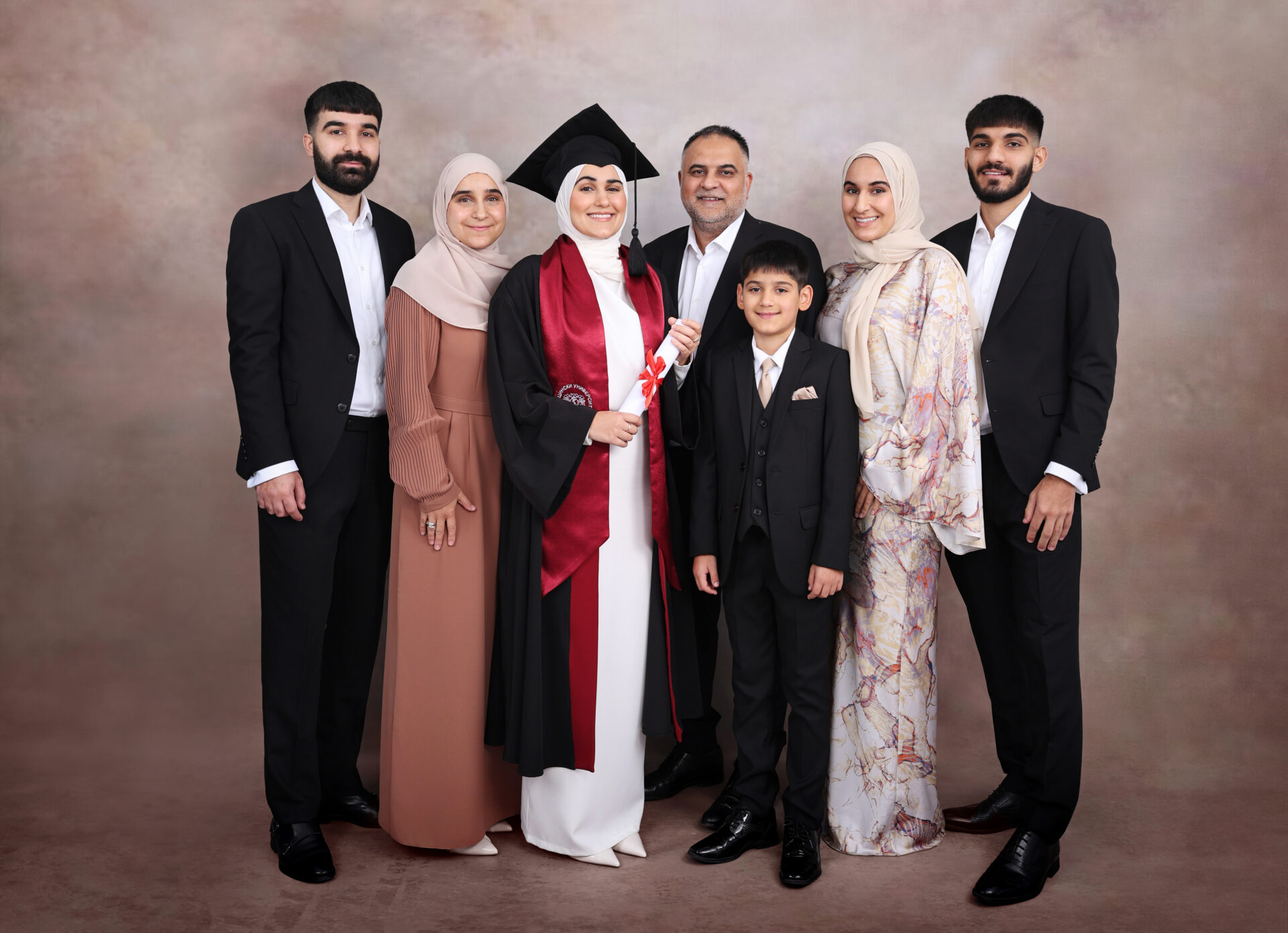 Family Graduation Photography with gown, mortarboard and hat.