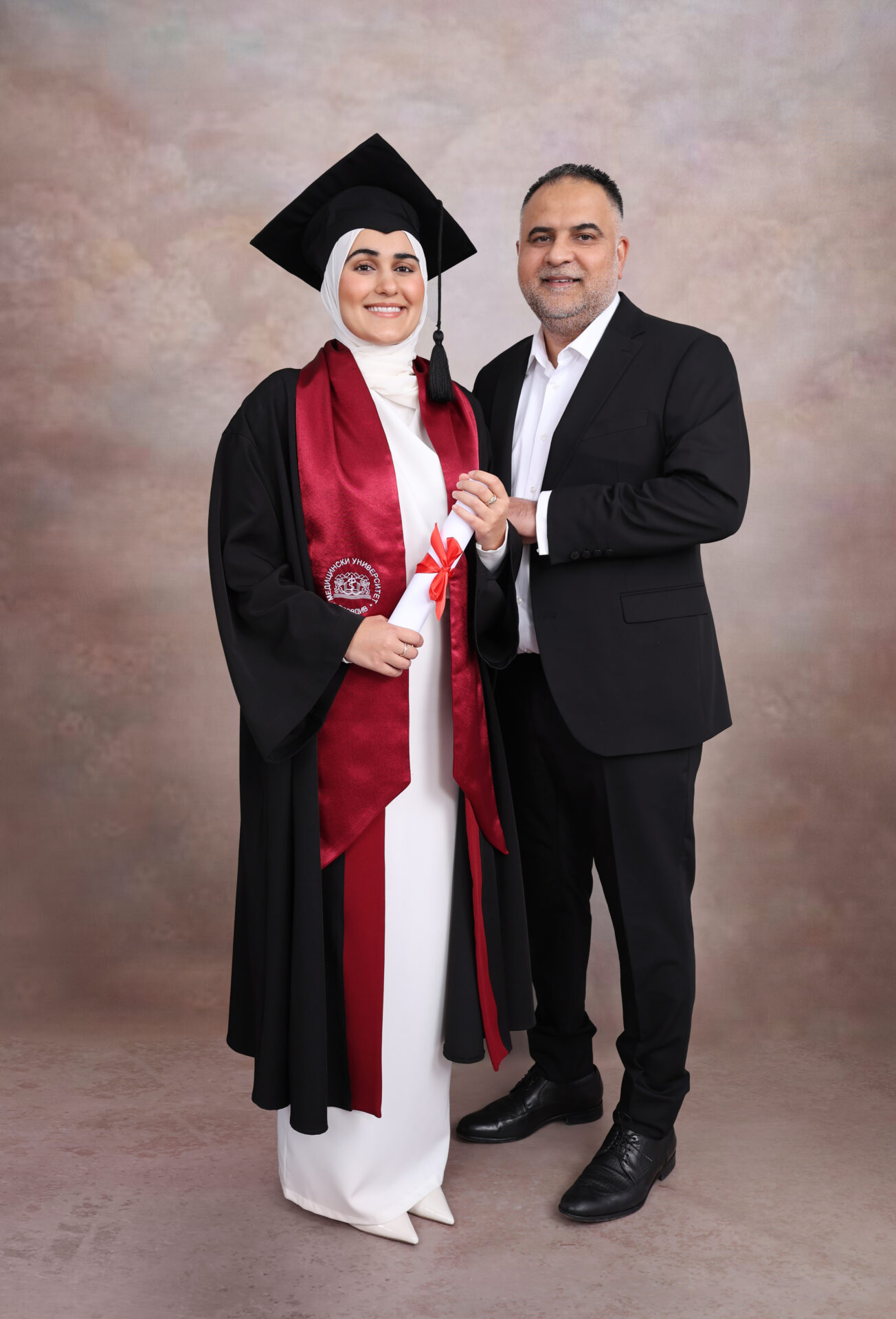 Family Graduation Photography with gown, mortarboard and hat.