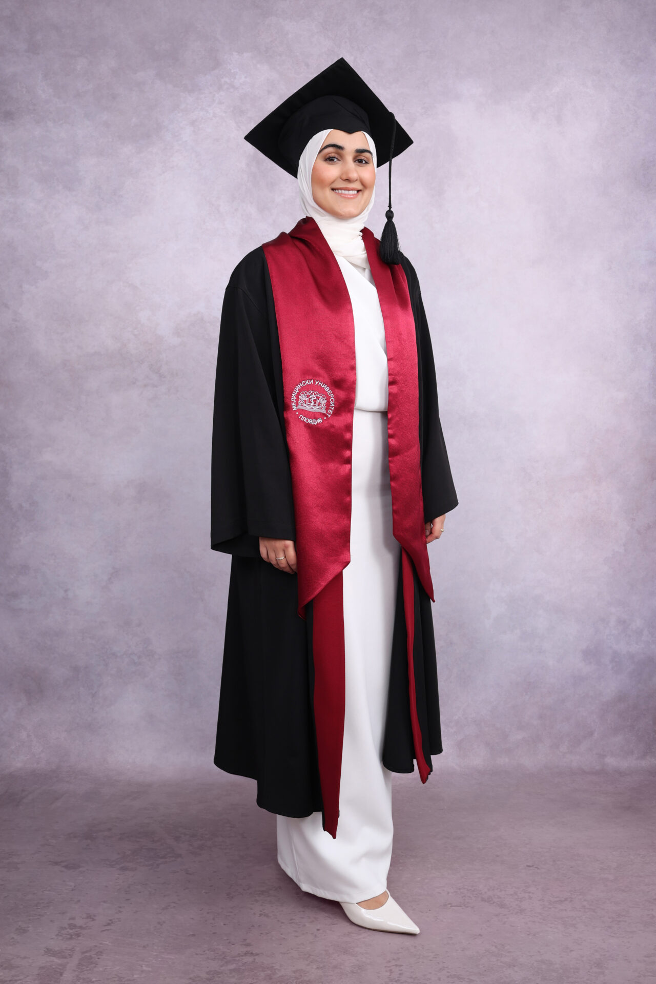 Family Graduation Photography with gown, mortarboard and hat.