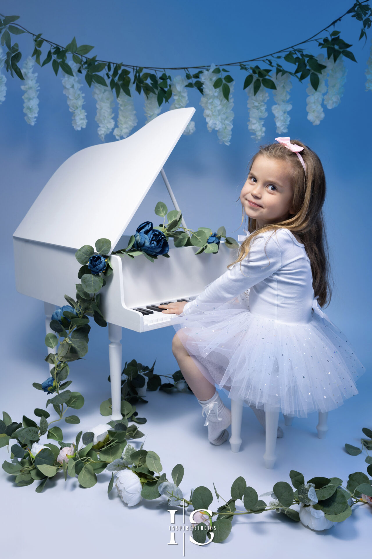 Little girl in a beautiful dress posing for a photoshoot by Inspire Studios