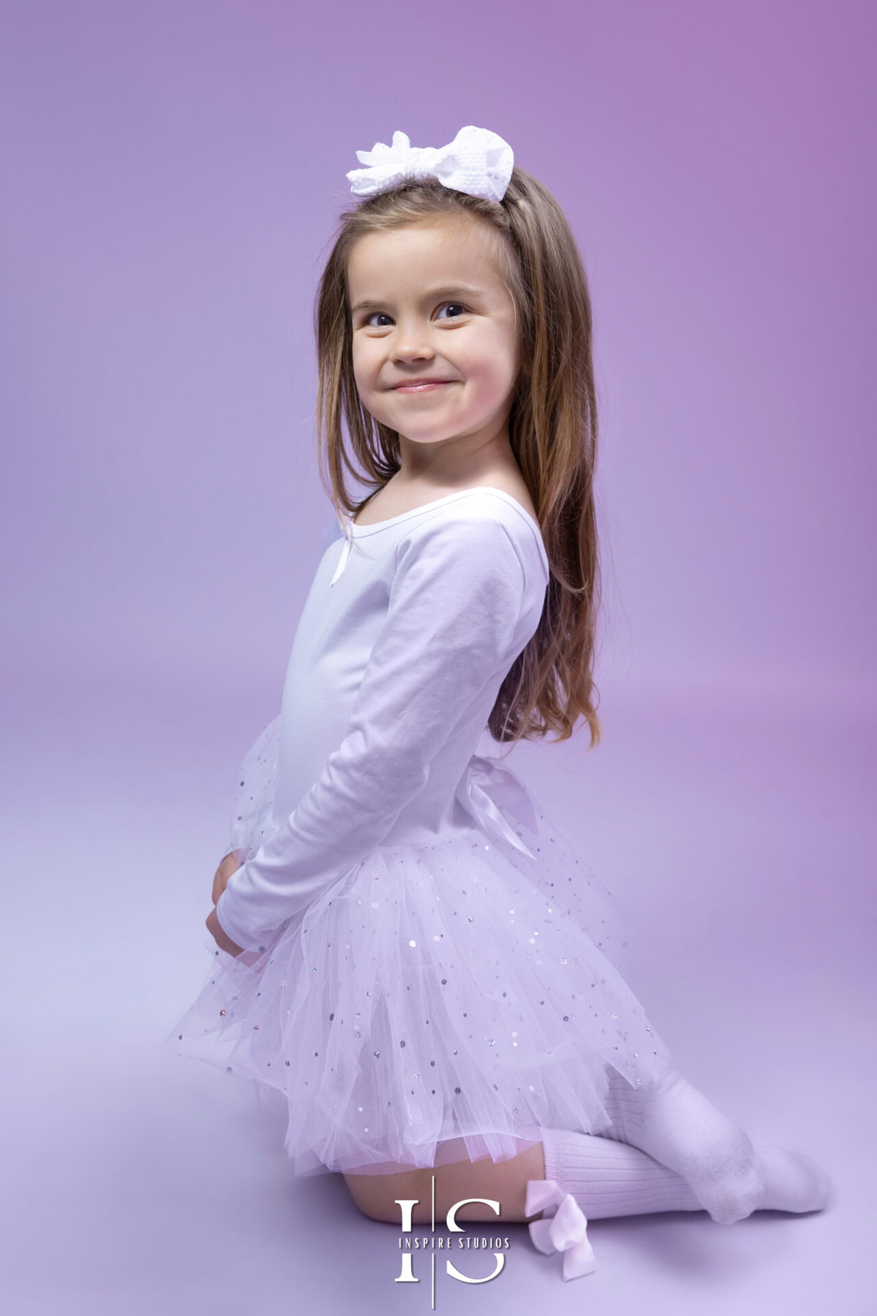 Little girl in a beautiful dress posing for a photoshoot by Inspire Studios