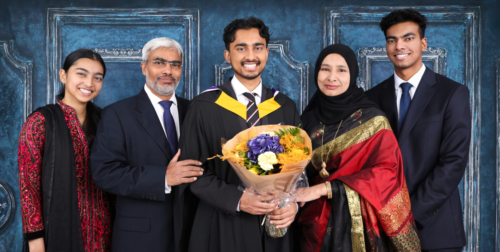 Family Graduation Photography with gown, mortarboard and hat.