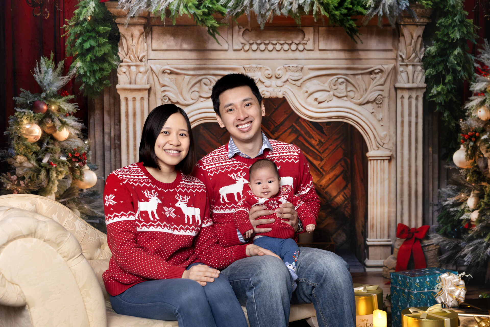 A cozy Christmas room with a classic fireplace, Christmas tree, and traditional red and green decorations.