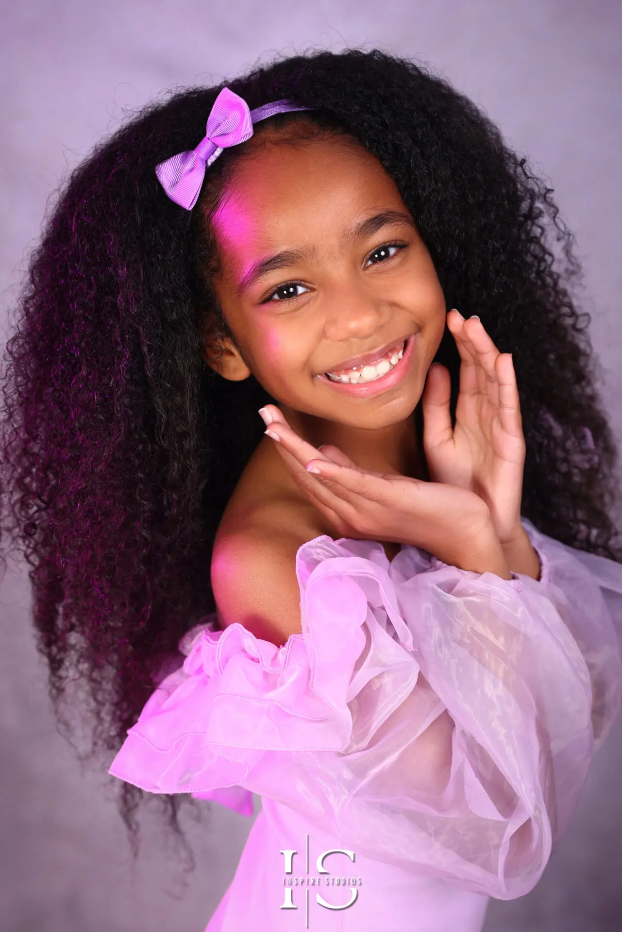 Professional children headshot photoshoot of a smiling child with natural lighting, clean background, and expressive portrait style.