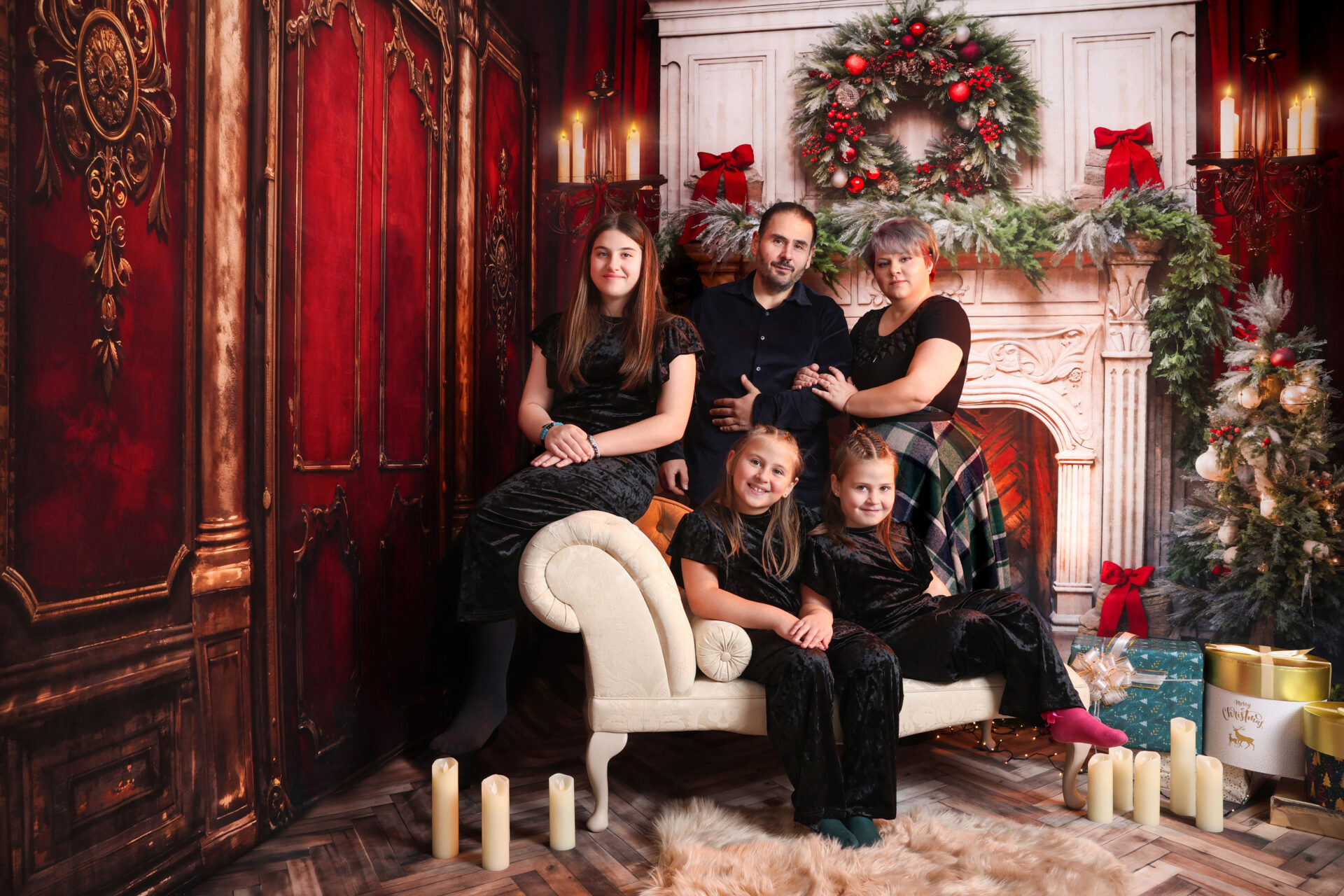 Family dressed for christmas mini session captured by female photographer in studio.