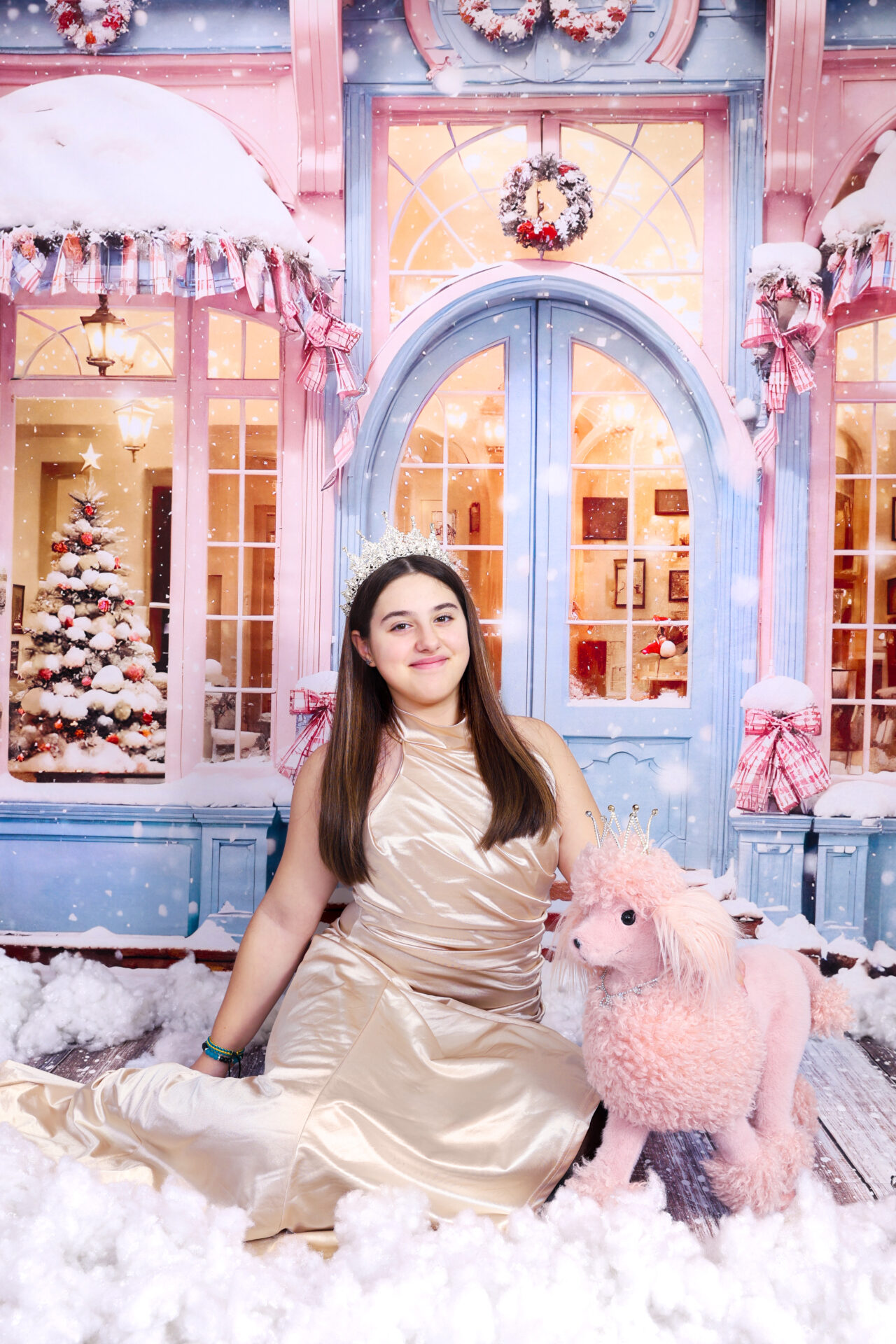 Girl dressed in golden yellow dress with a pink dog captured in festive pink decor in studio.