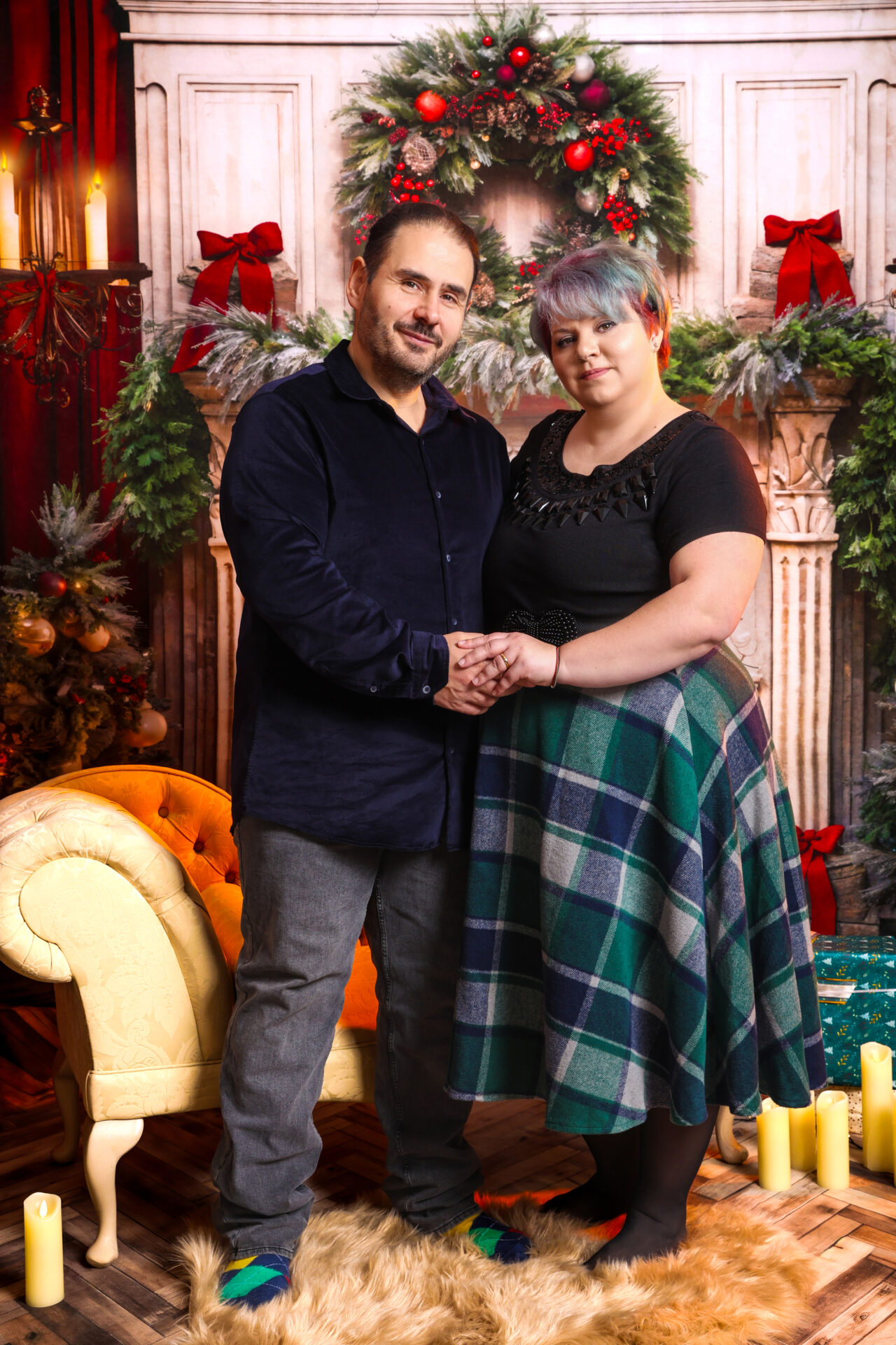 Couple dressed for christmas mini session captured by female photographer in studio.