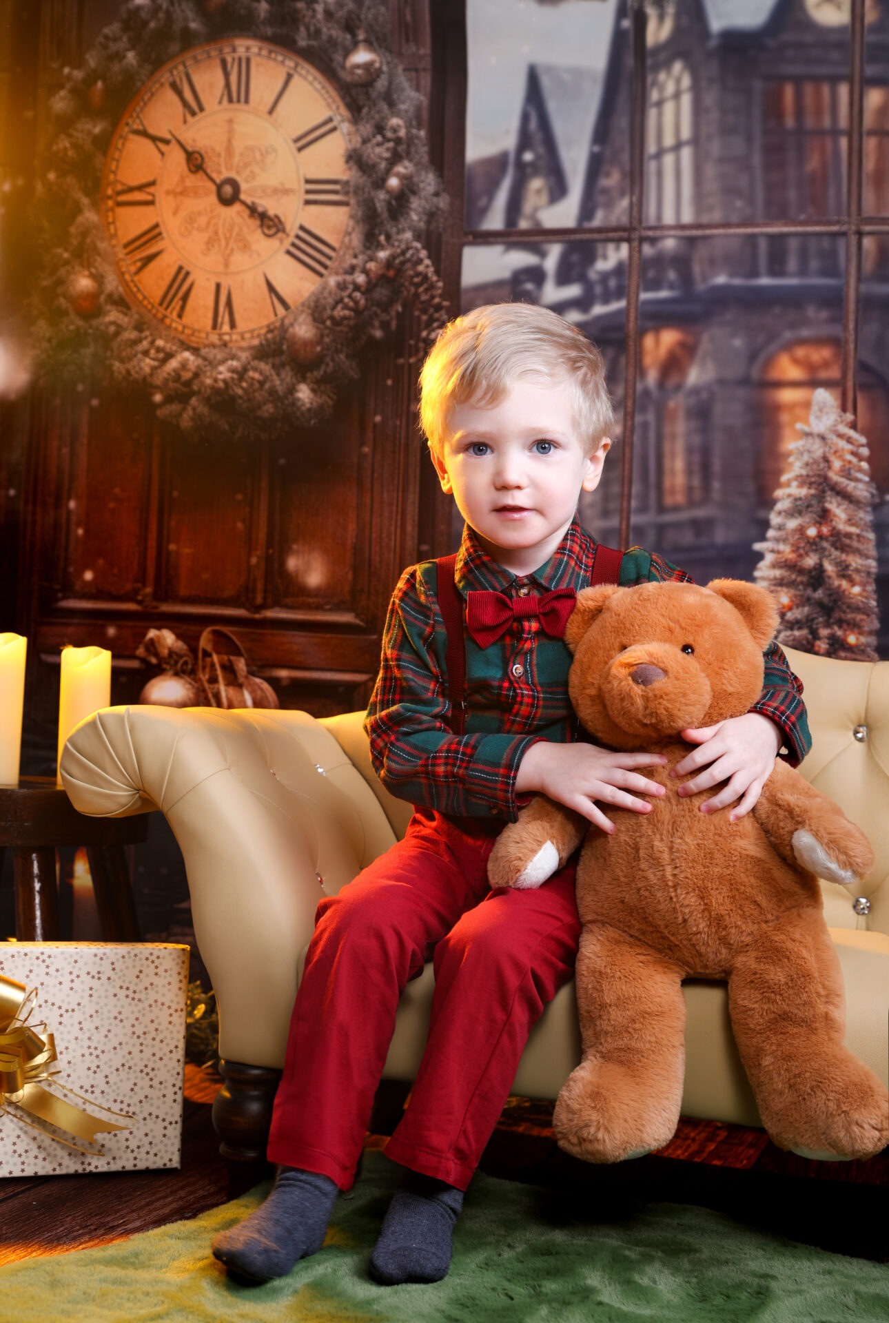 Kid holding a teddy bear against a festive christmas backdrop for children.