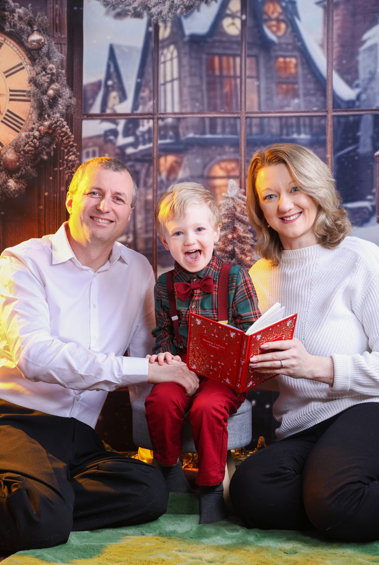 Family sitting on a christmas decor during a photo session in studio based in Walthamstow.