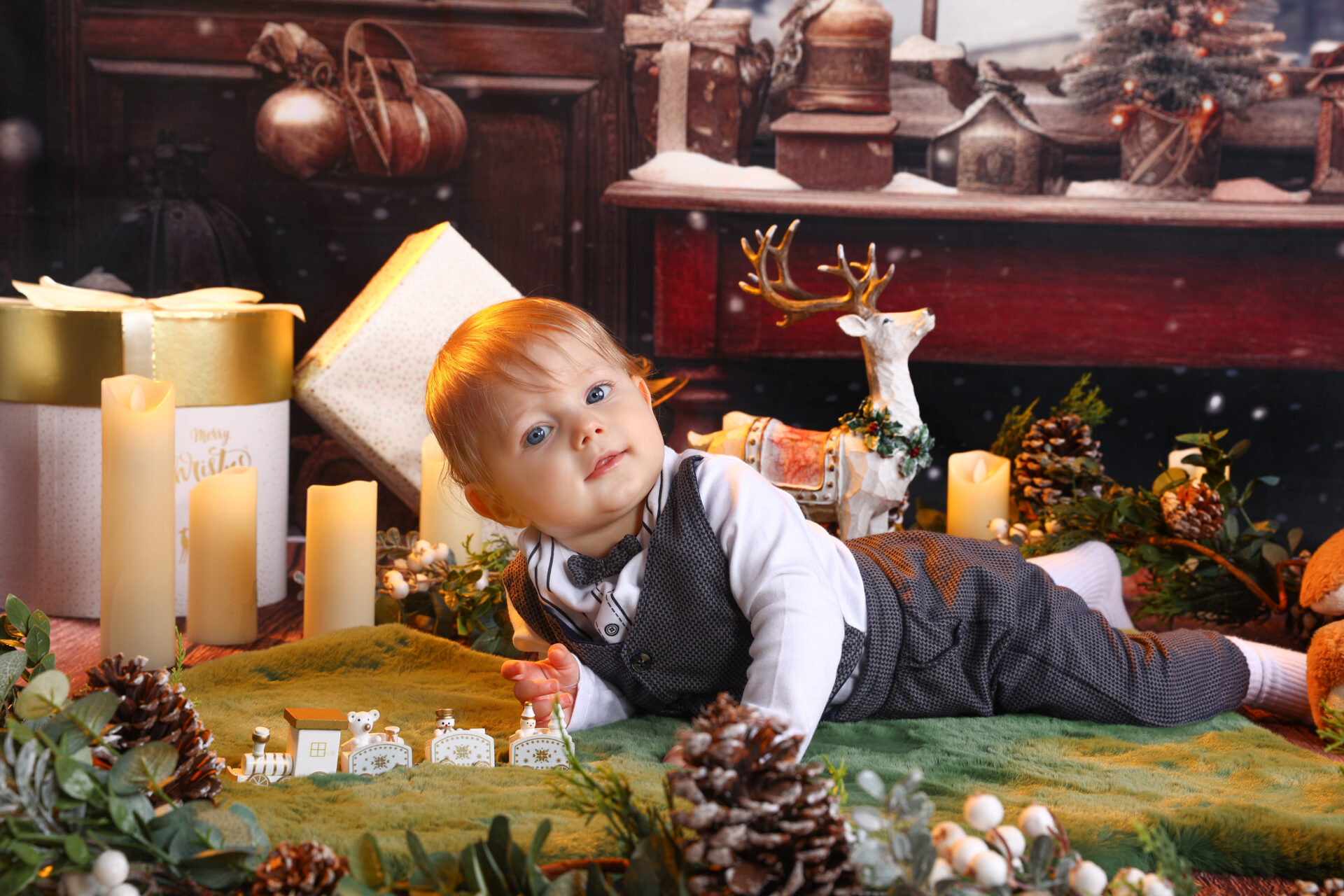 A child playing on a christmas festive decor in a photo studio.