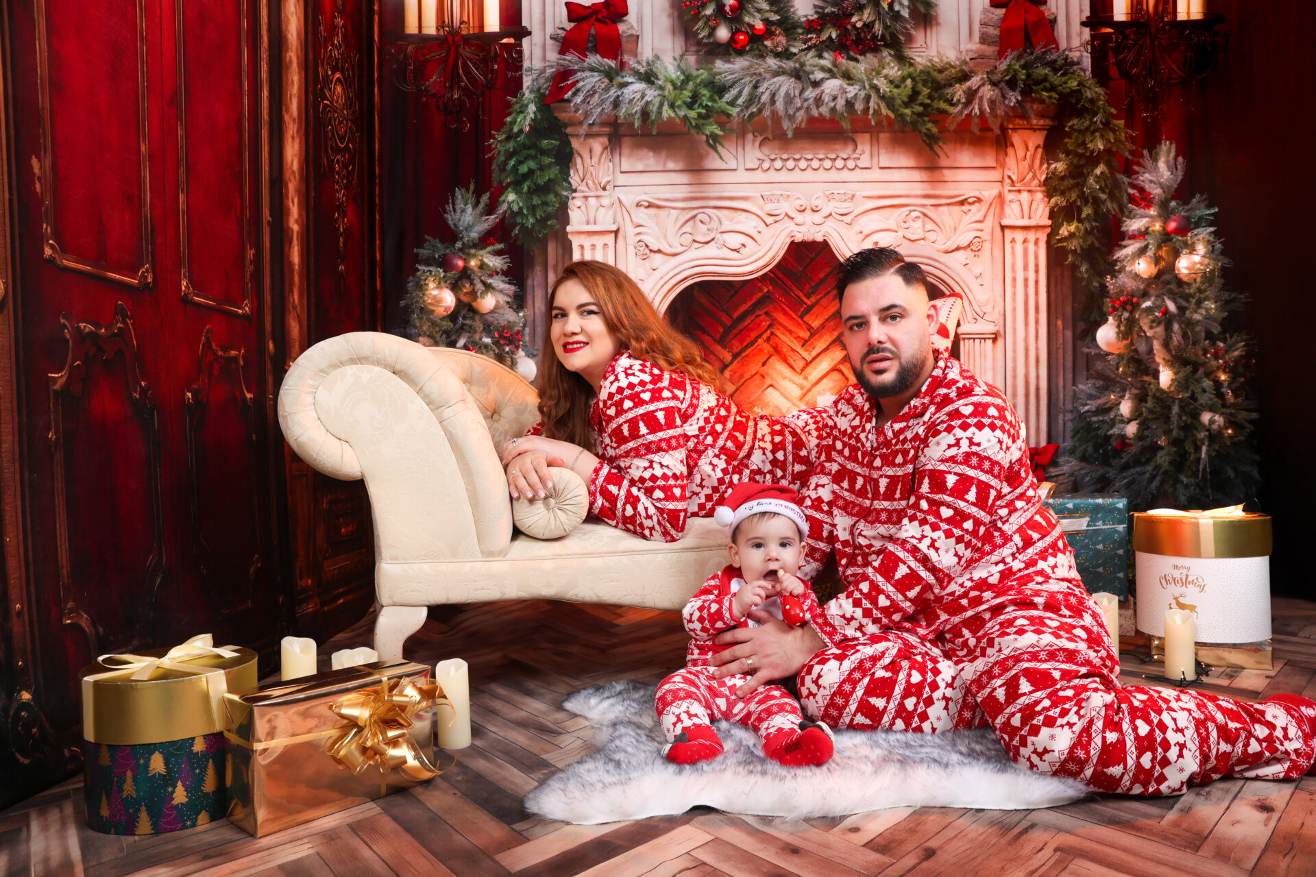 Family sitting on a coach against christmas festive decor during a family festive photoshoot in London.