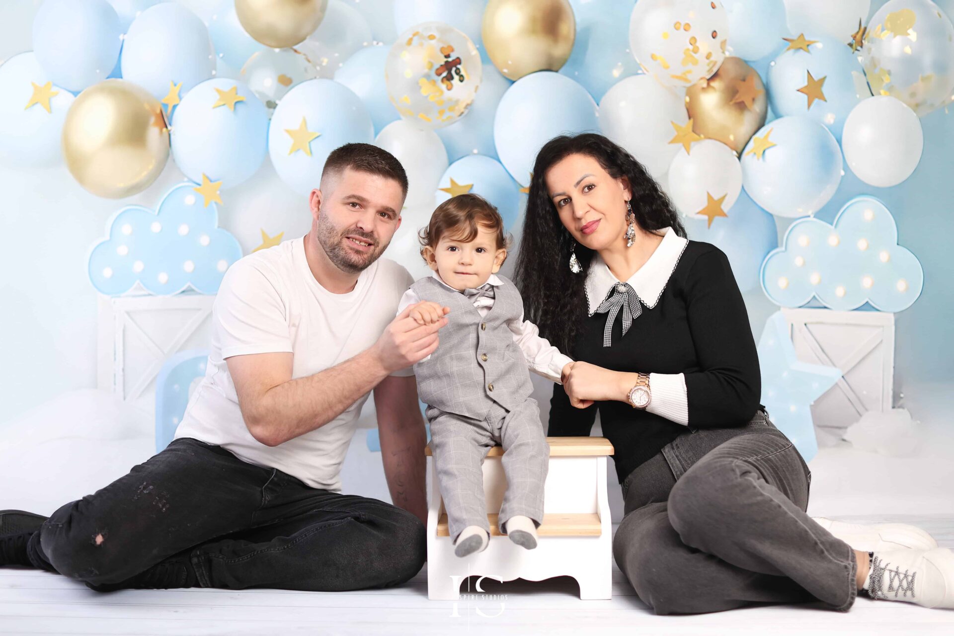 First Birthday Photoshoot session with happy family in photo studio based in London.