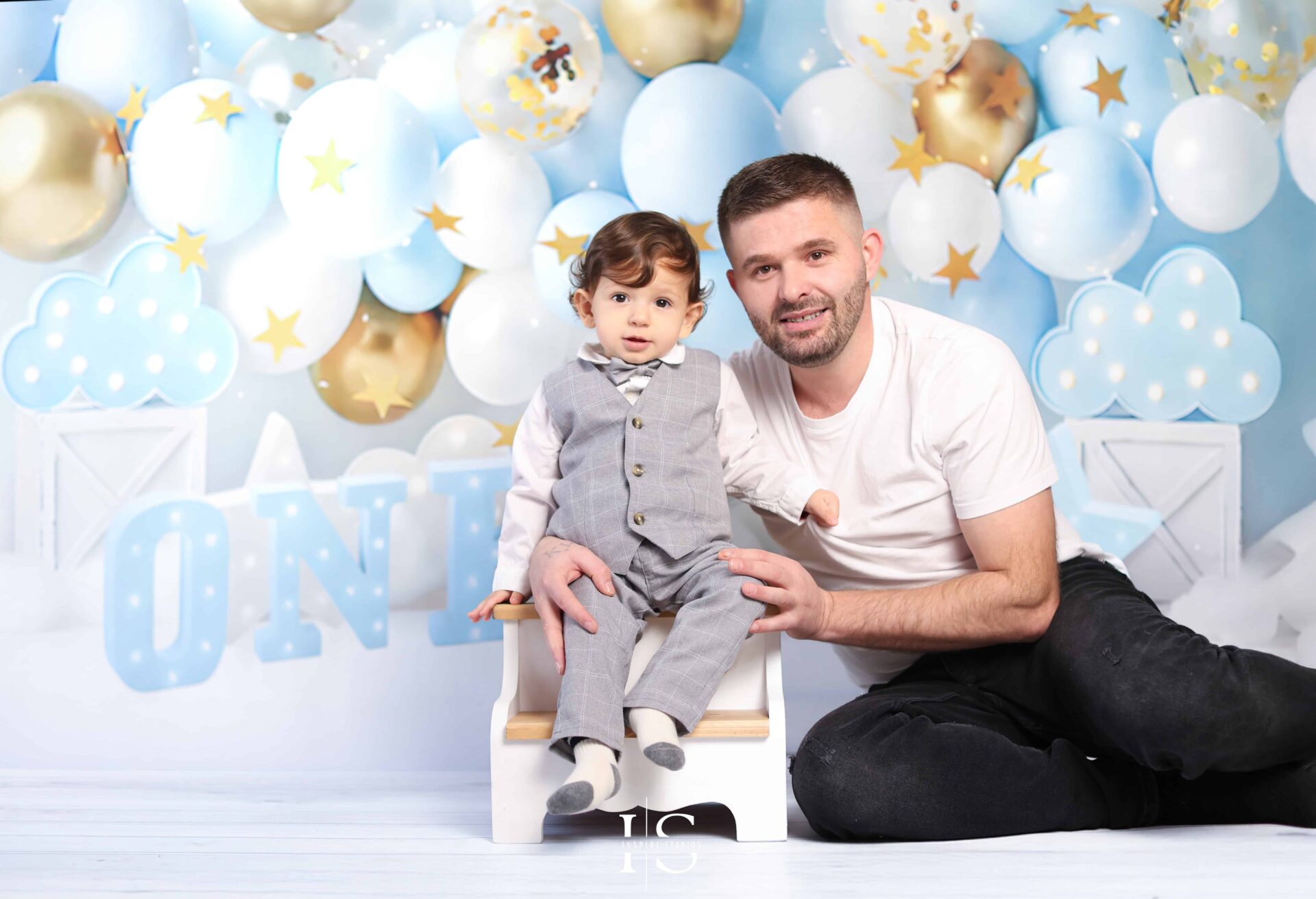 First Birthday Photoshoot session with happy toddler and father in photo studio based in London.