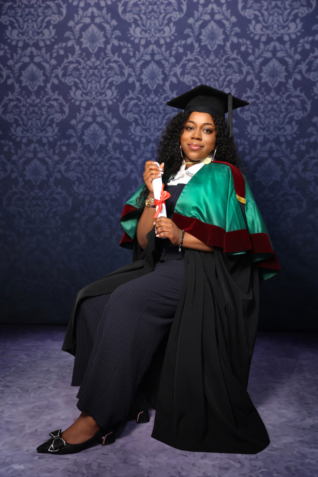 Graduate posing in London studio with budget-friendly graduation photographer.