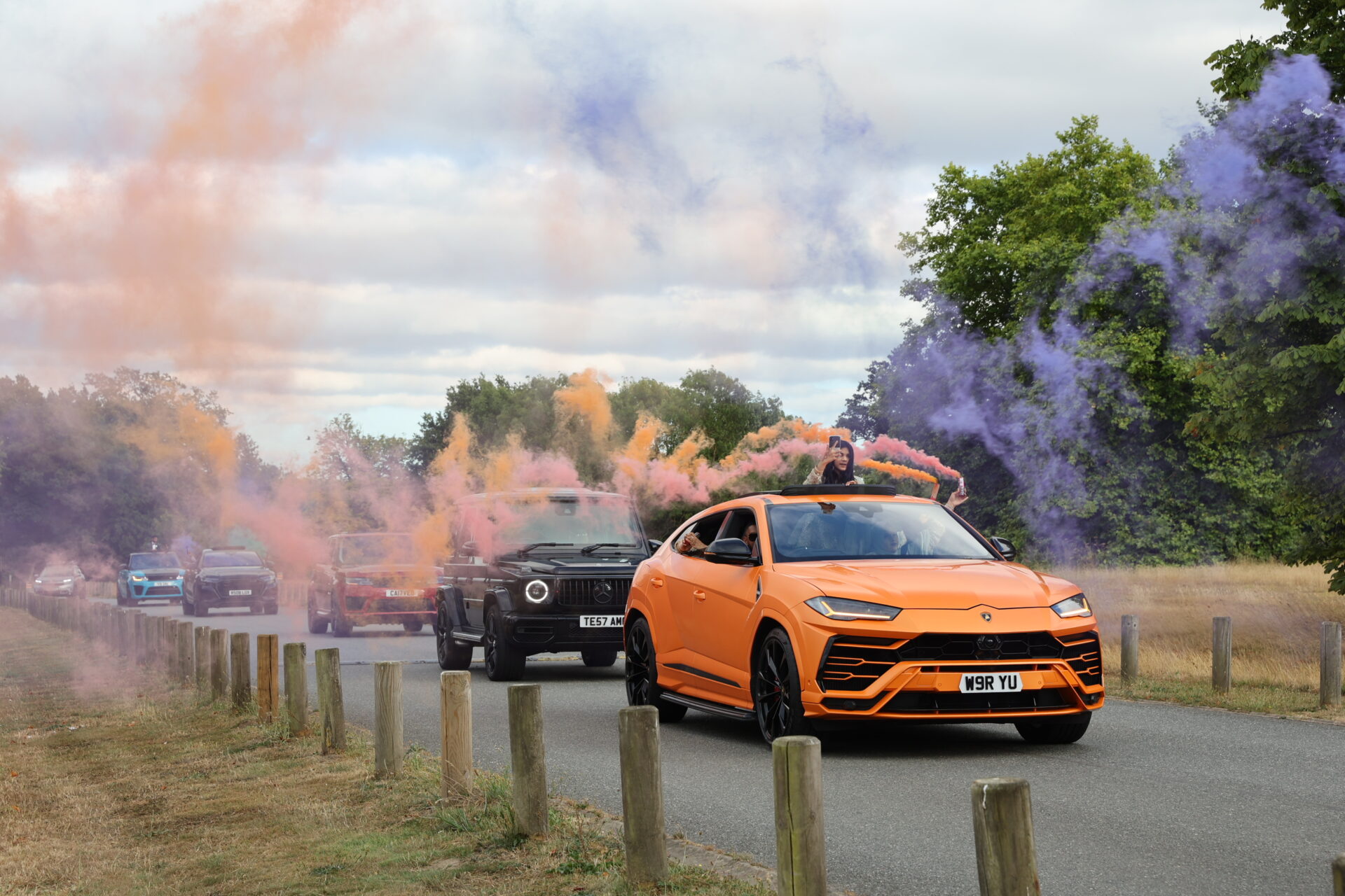 Baraat wedding photographer capturing groom's big entrance with cars.