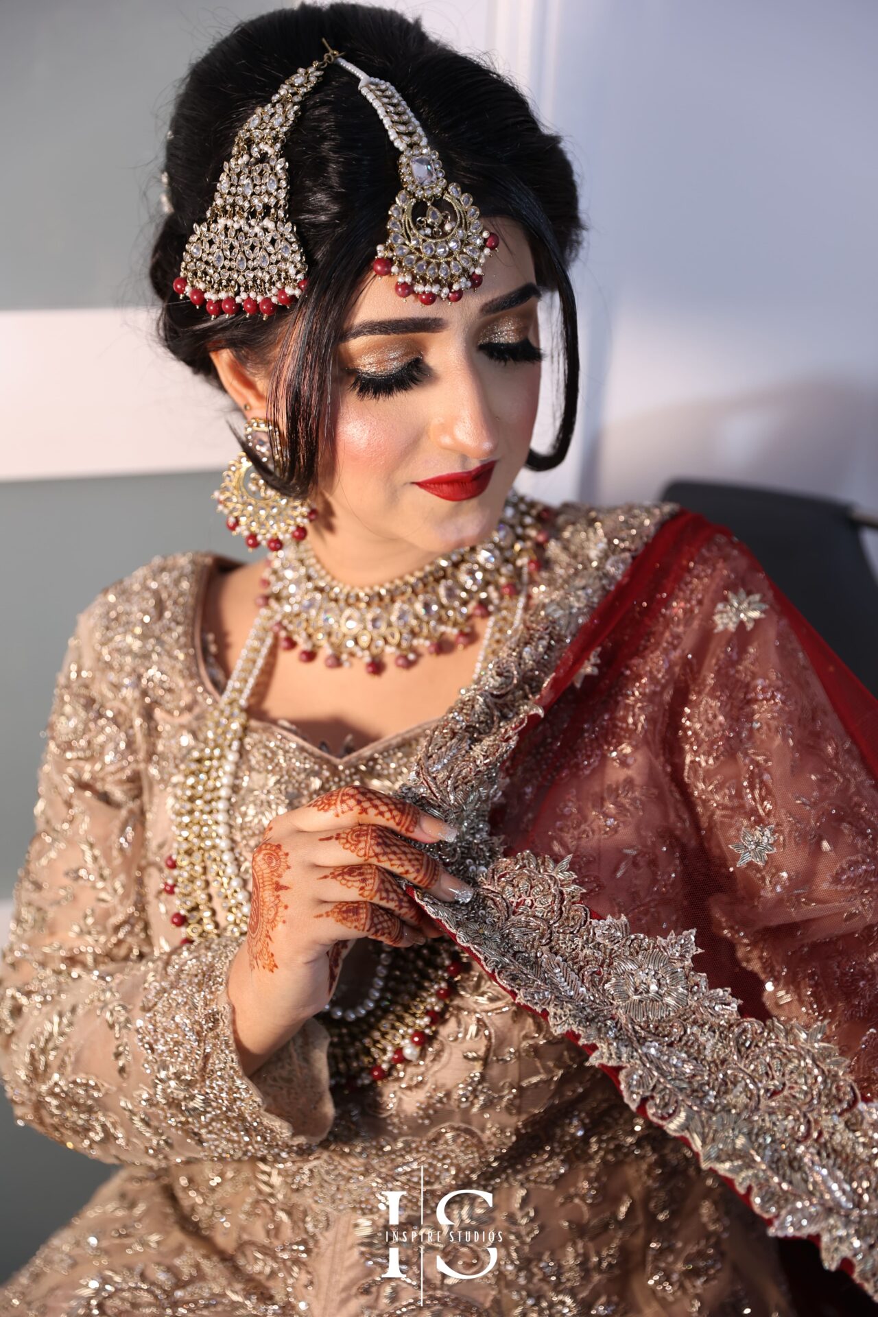 Bride getting ready during baraat wedding photography in London.