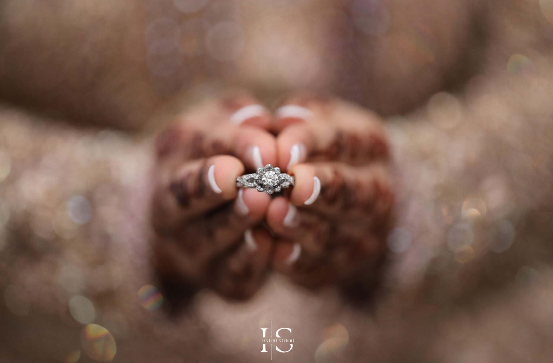 Bride adjusting her traditional golden jewelry during her baraat wedding preparation.