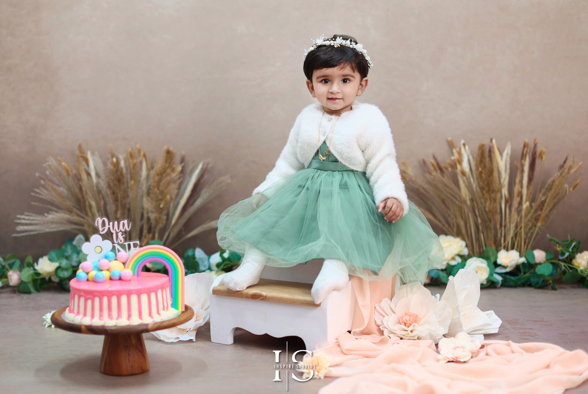 Adorable cake smash session in London with colorful decorations and a smiling baby.