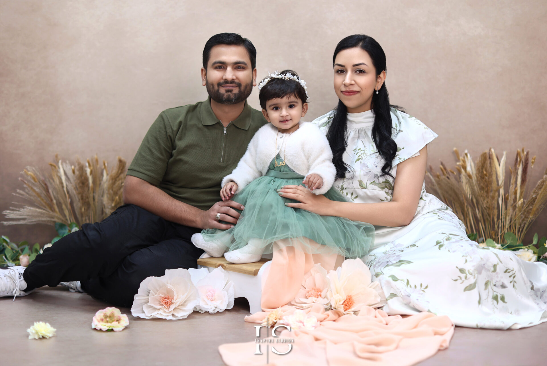 Baby celebrating first birthday during a vibrant cake smash photoshoot in London studio.