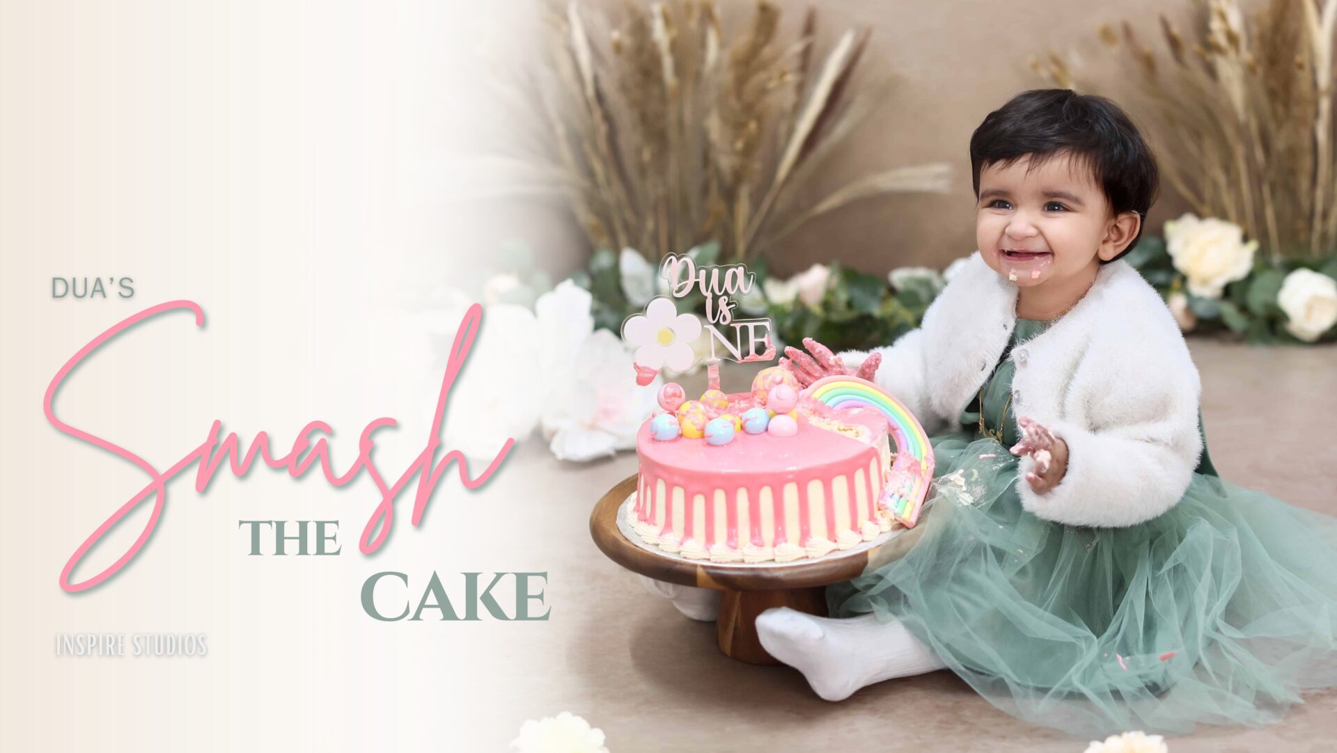 Baby’s first birthday cake smash photoshoot in London with pastel-themed decor and colorful cake.