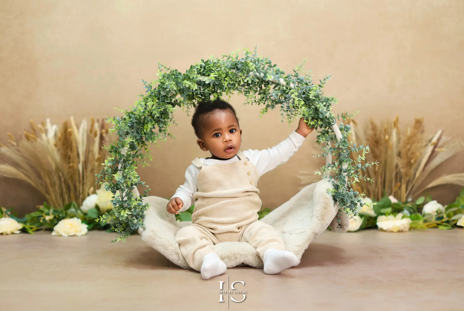 Adorable toddler posing for first birthday photoshoot in London.
