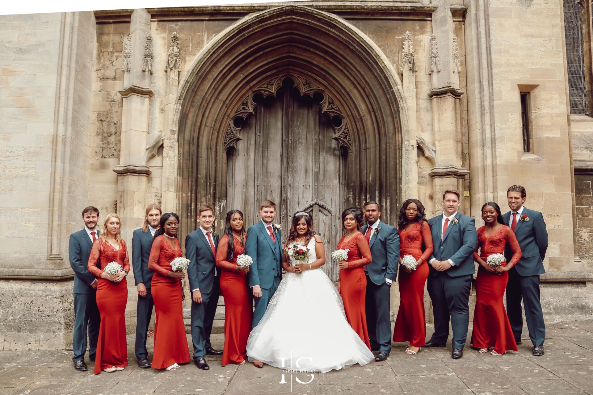 Bride and groom with bridesmaids and groomsmiths captured during a church wedding in London.