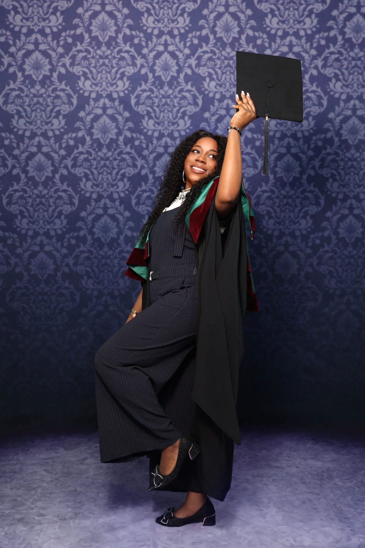 Elegant graduation portrait of woman taken in studio.