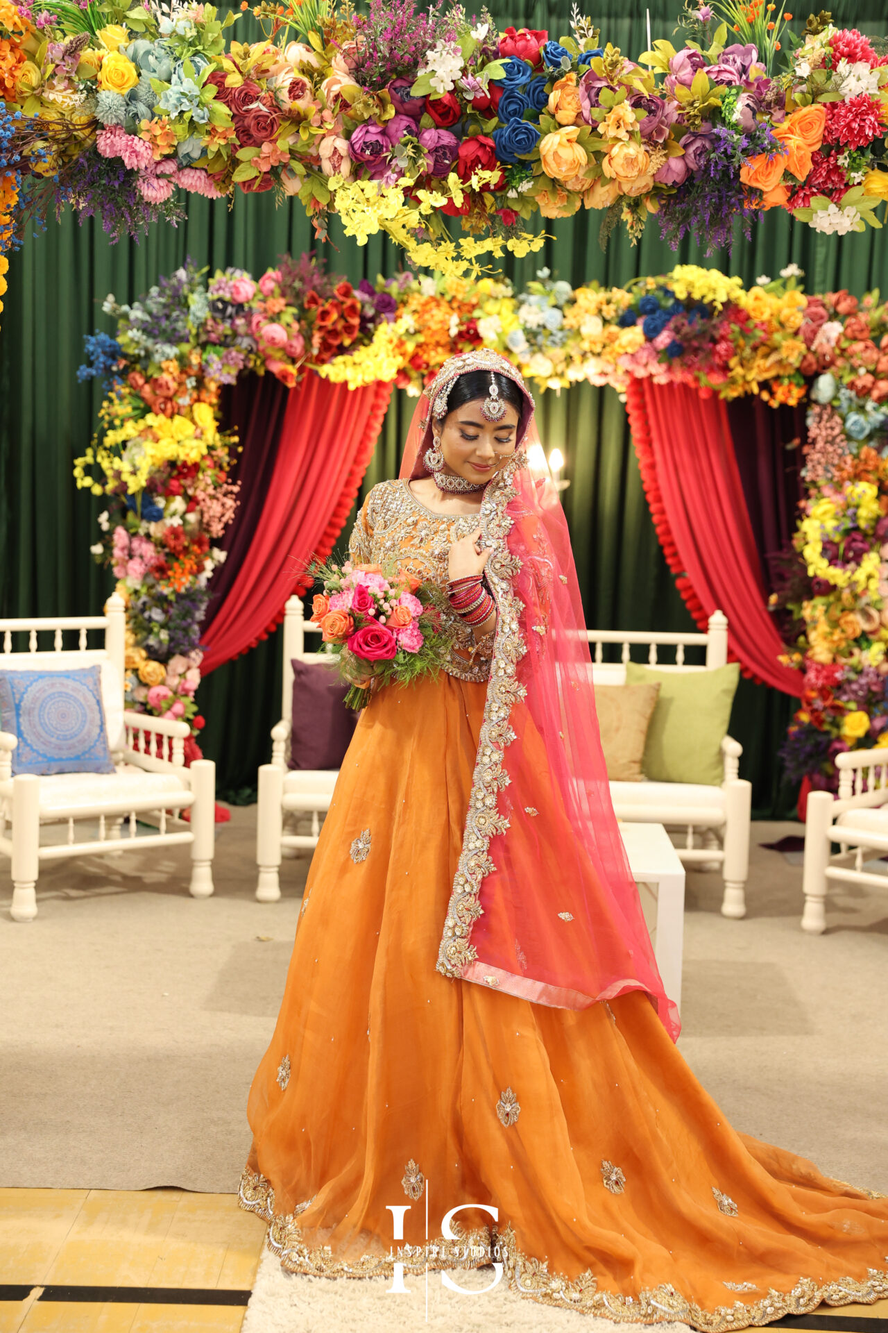 Bride wearing a traditional, vibrant outfit during her Mehndi wedding photography ceremony.