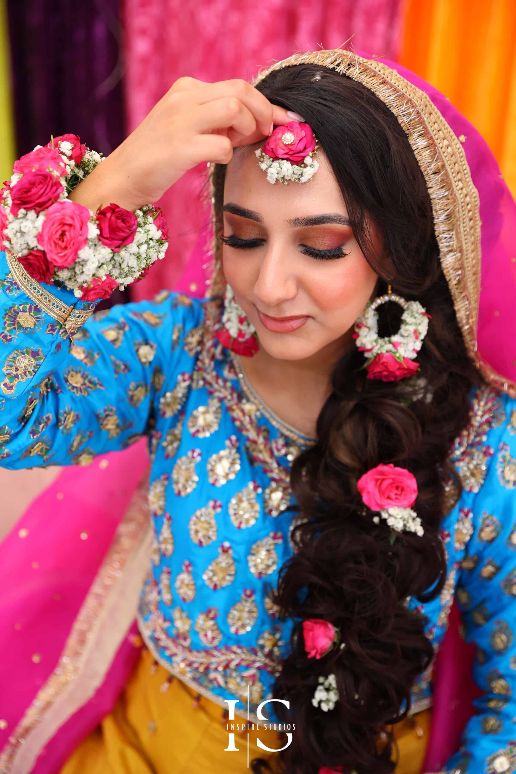 Bride wearing a traditional, vibrant outfit during her Mehndi wedding photography ceremony.