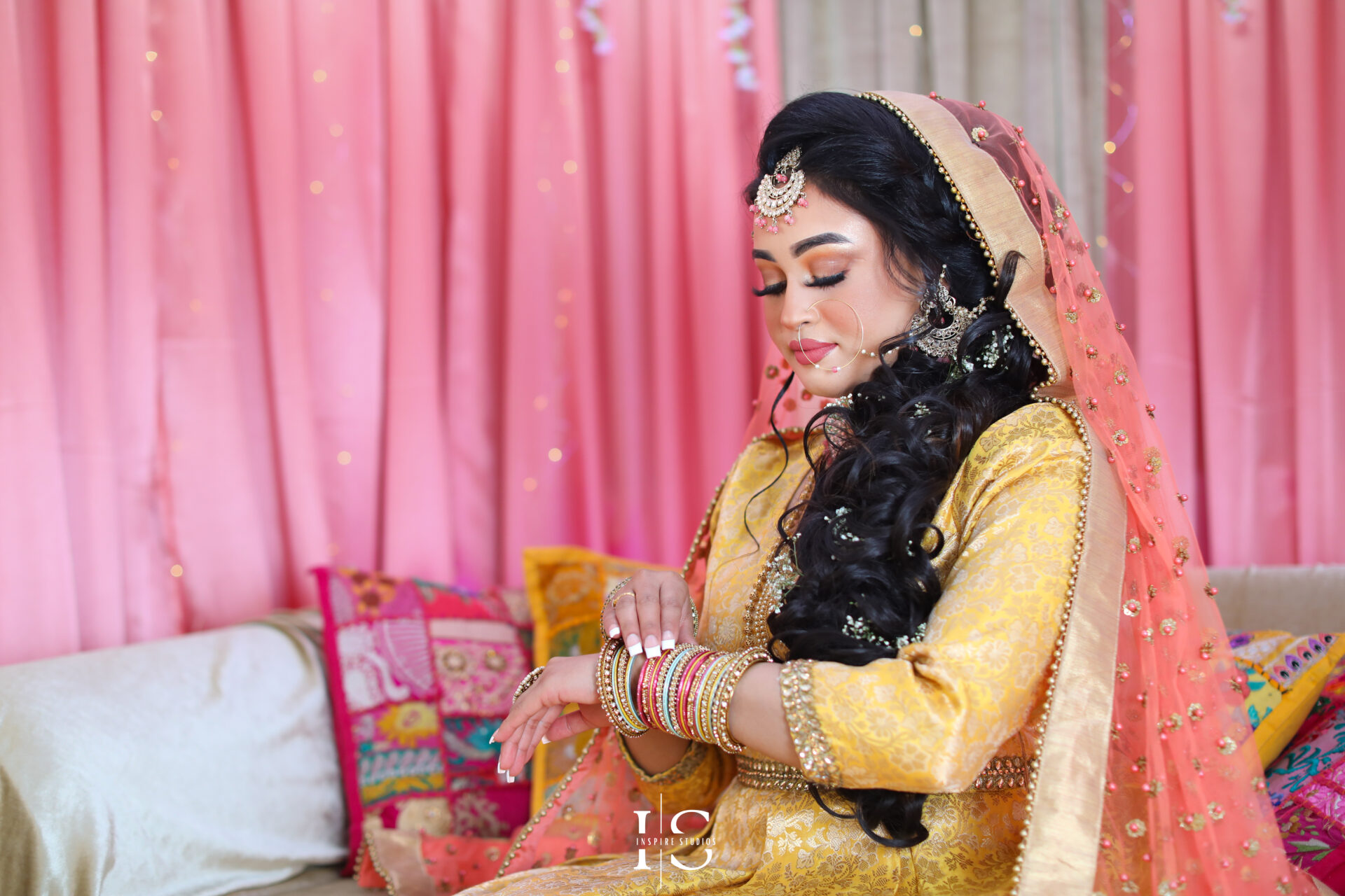 Bride wearing a traditional, vibrant outfit during her Mehndi wedding photography ceremony.