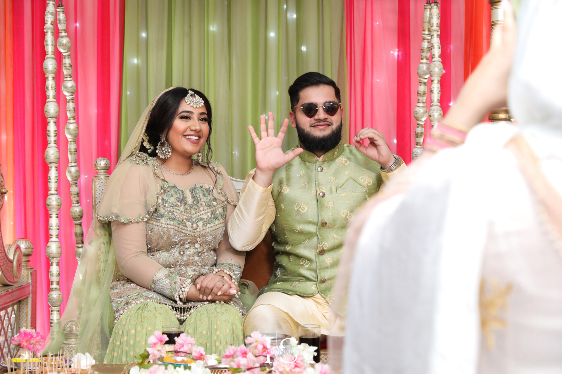 Bride posing with friends and family during her Mehndi wedding photography celebration.