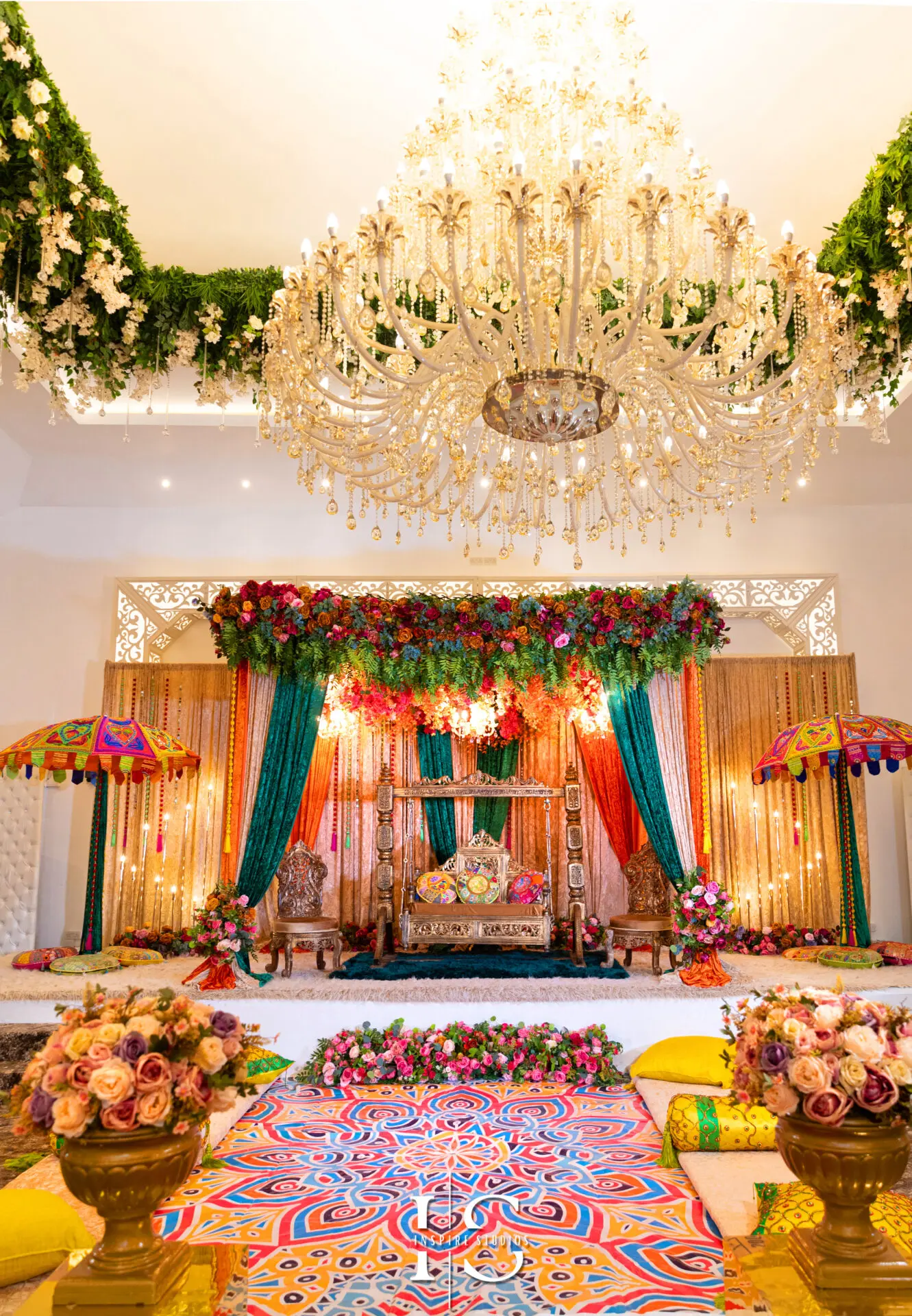 Beautiful Mehndi Wedding Photography decorations with colorful drapes and floral arrangements.