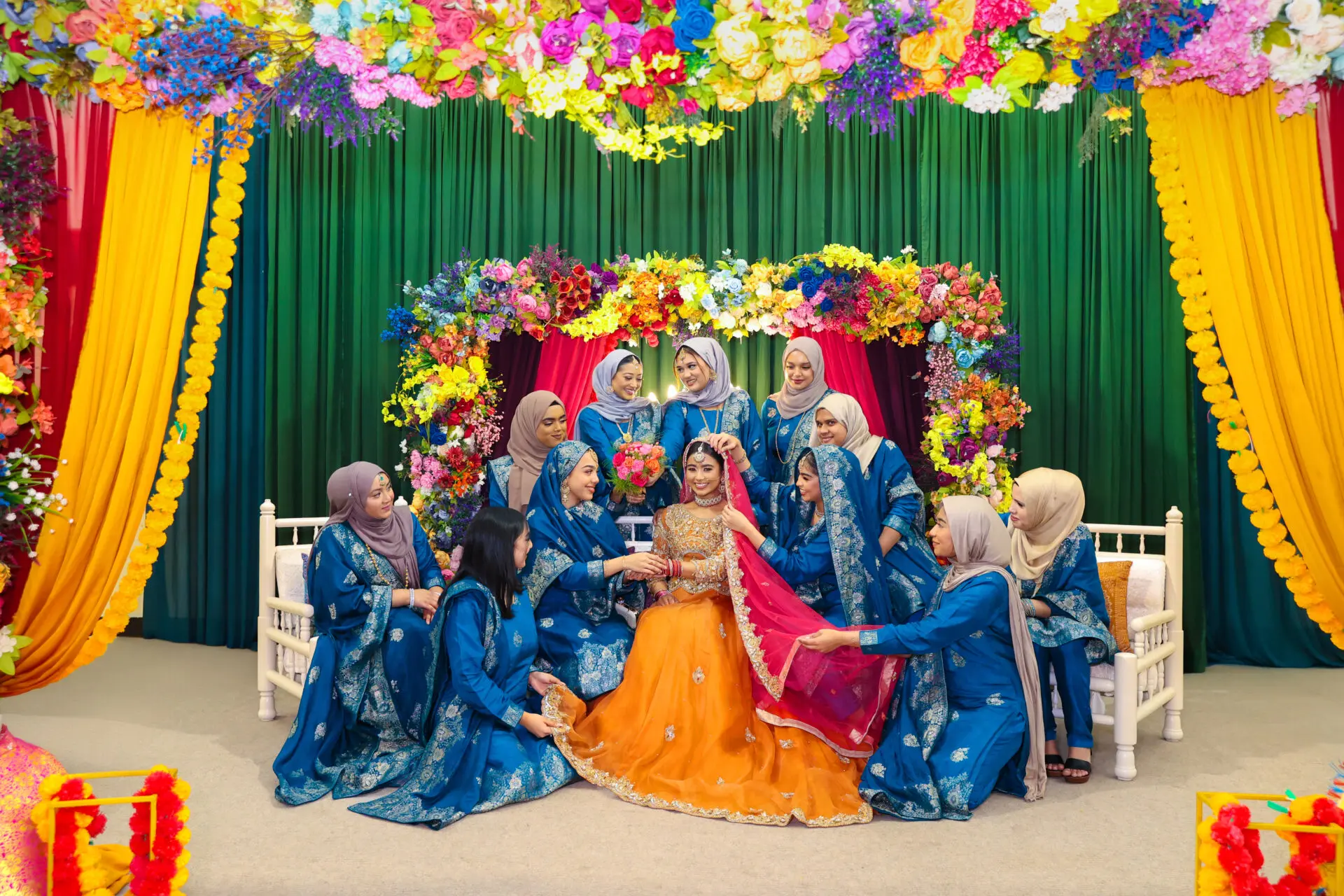 Heartwarming group portraits on the stage that highlight the bonds of love and togetherness of the families. Individual shots of each bride’s family member standing to show the specially chosen outfit for the day.