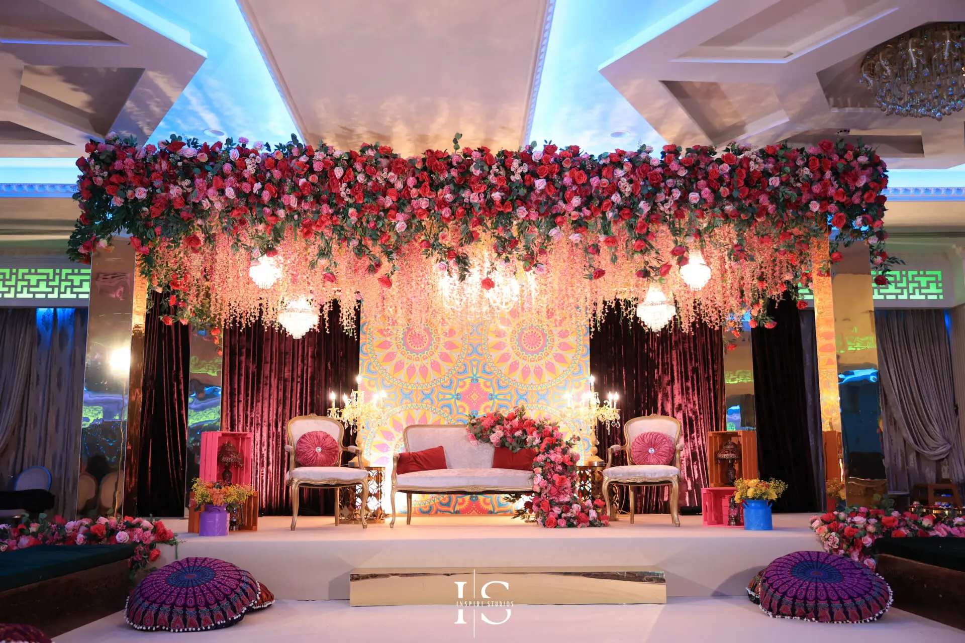 The stage is the heart of the celebration. From the elegantly layered colorful drapes to the intricate decor of the venue, every detail is noticed and captured – including the personalised welcome board and the vibrant dholki area.