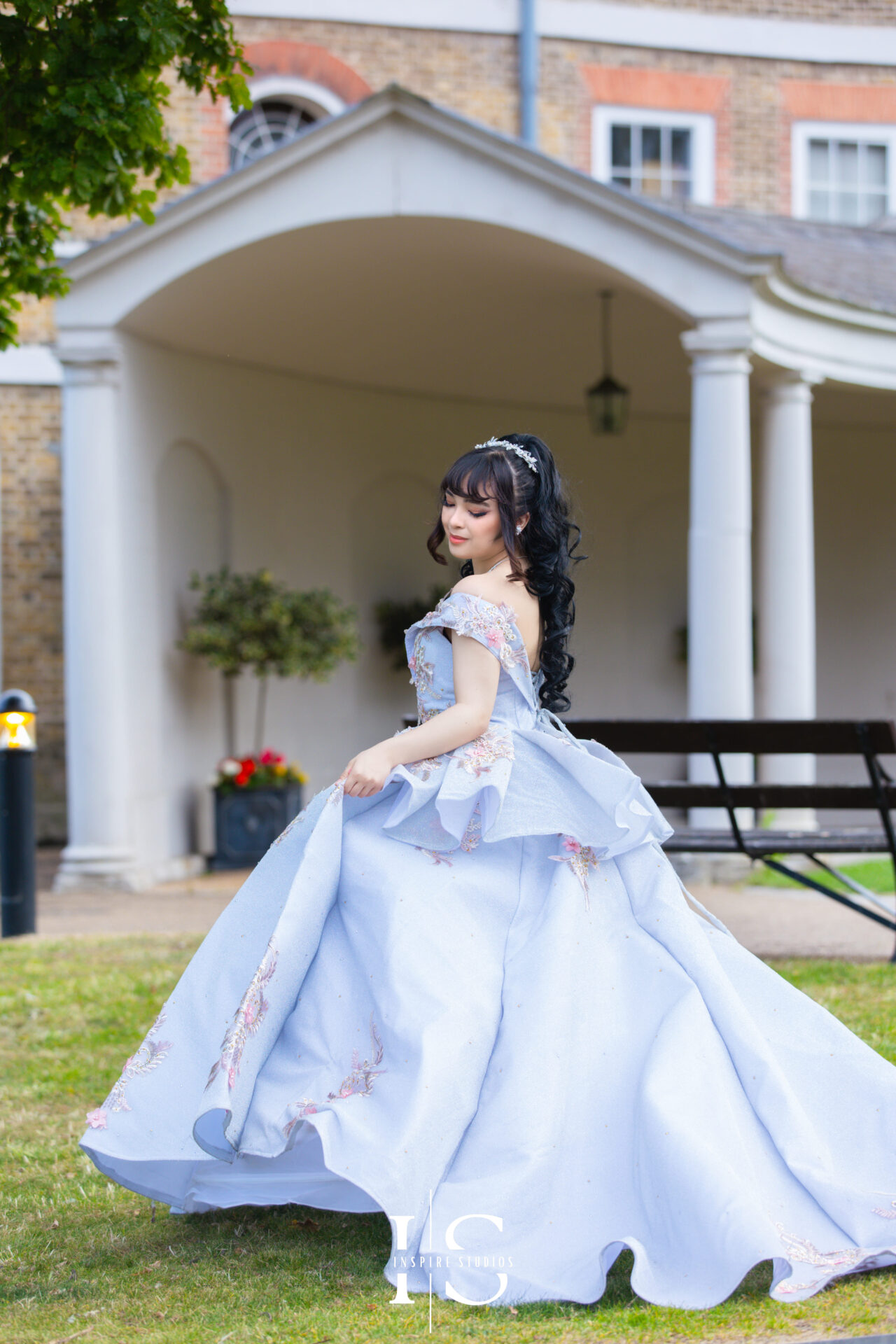 Young woman in a nice blue dress during a prom outdoor photoshoot in London.