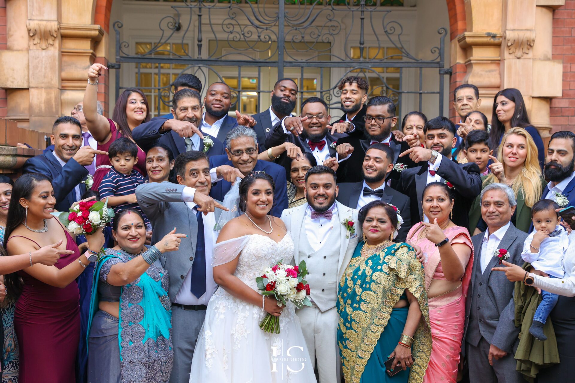 Bride and groom posing with family and friends after their registry ceremony wedding in London.