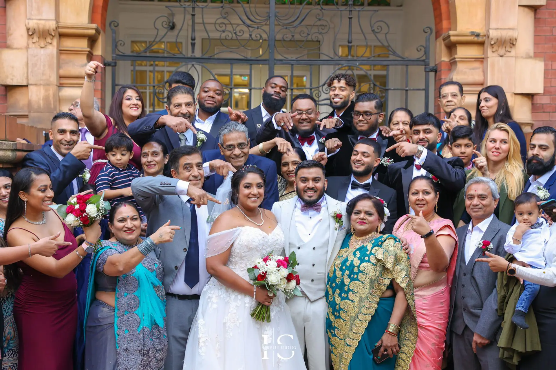 Bride and groom posing with family and friends after their registry ceremony wedding in London.