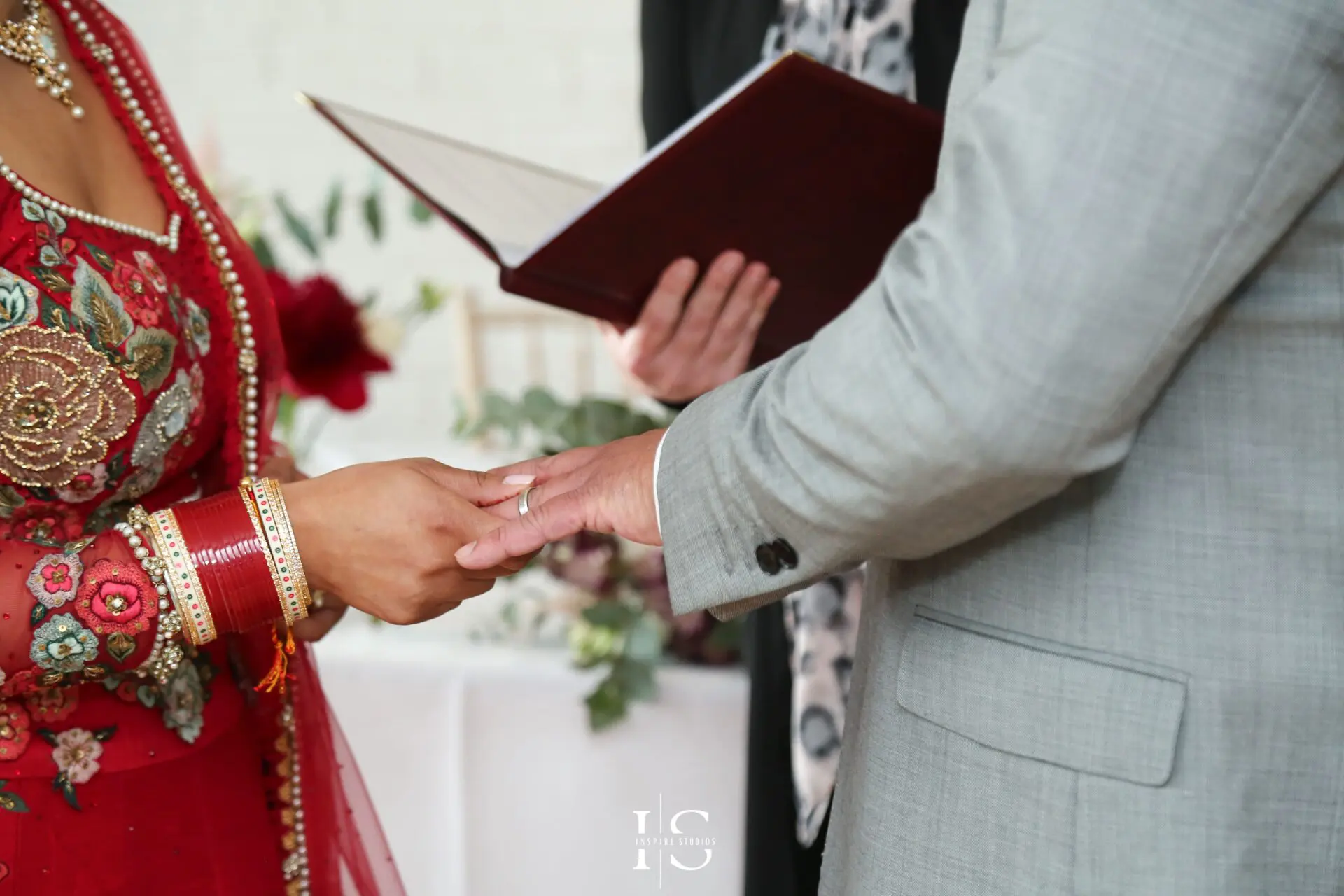 Husband and wife holding hands together during they registry ceremony in town hall.