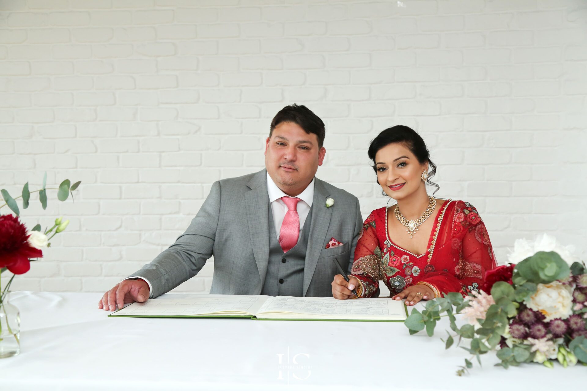 Bride and groom signing moment captured at a registry ceremony in London.