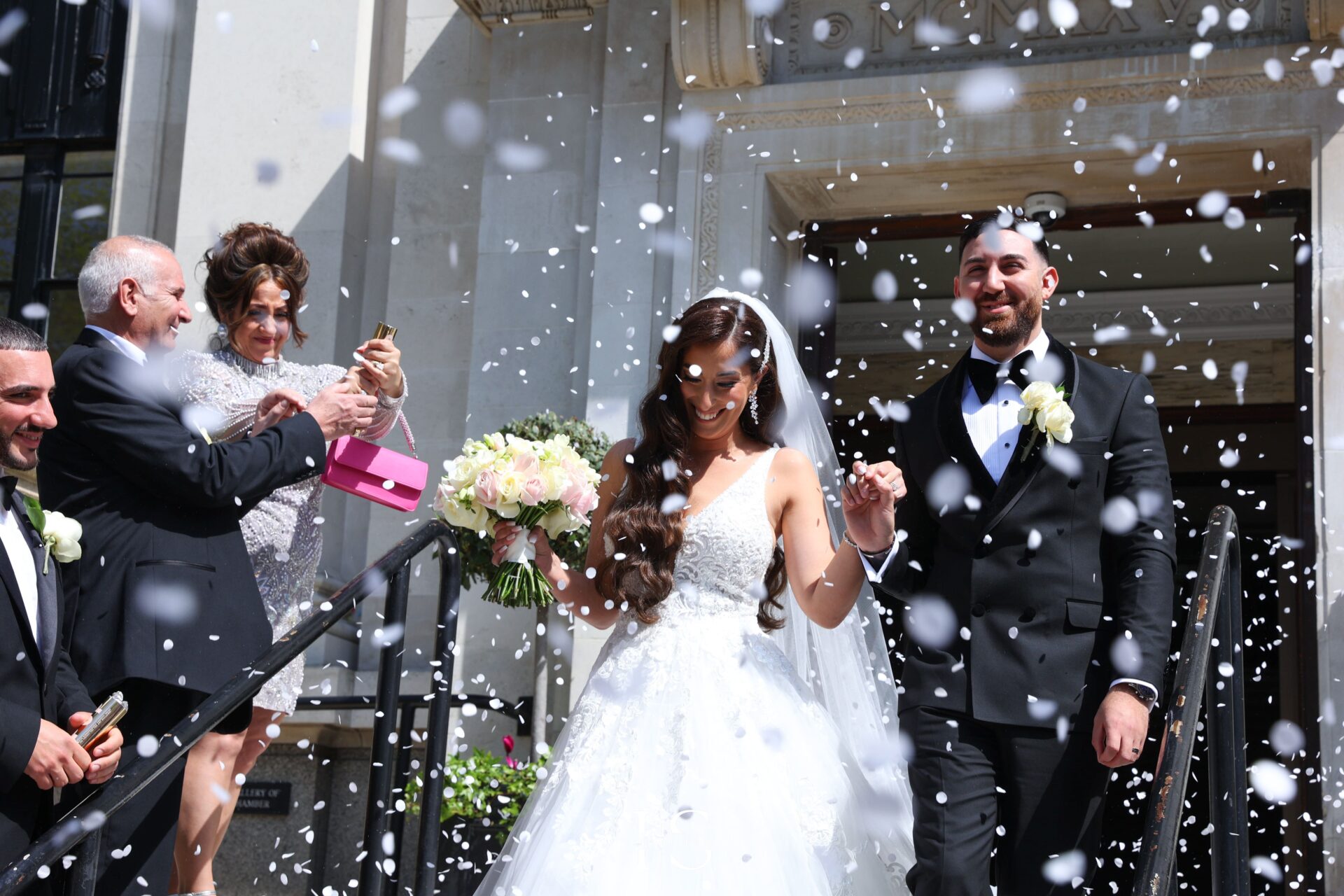 Wedding ceremony photographer in London posing bride and groom congratulated after their ceremony.