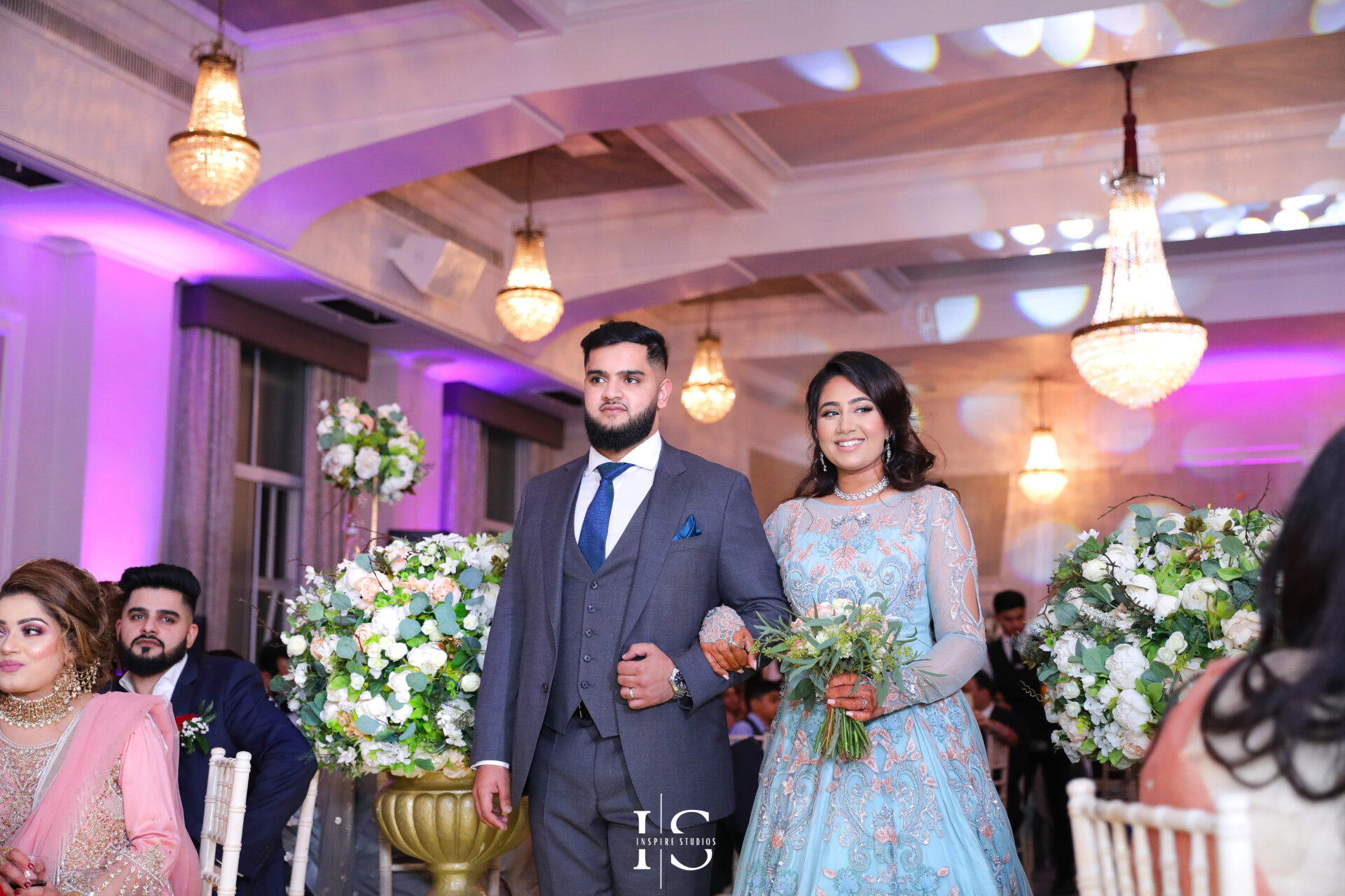 Walima female wedding photographer in London capturing bride and groom entrance.