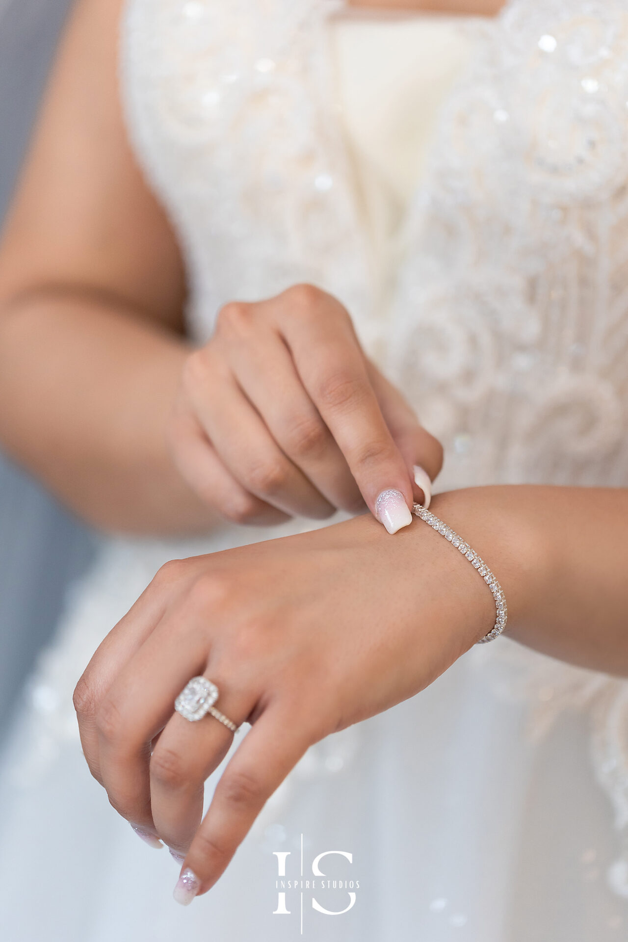 Wedding photographer in London documenting bride's adjusting her bracelet during her wedding day.